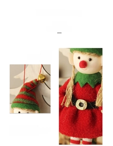 Detail of a Christmas elf doll ornament with striped hat, golden bell, and knit texture