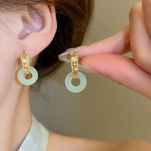 Gold plated jade-style ring earrings with zircon accents on a model for a refined look
