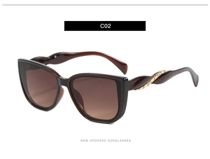 Close-up of wine red cat eye sunglasses with golden braided texture detail on temples