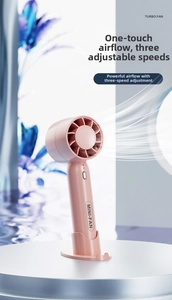 Pink portable mini turbo fan detail with round base and one-button control interface