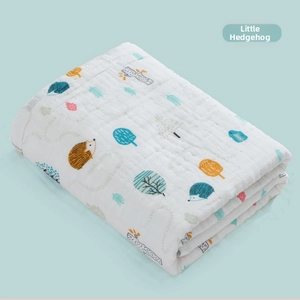 Detail of soft 6-layer cotton baby swaddle blanket featuring a little hedgehog print
