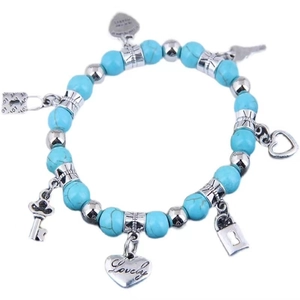 Bohemian beaded turquoise bracelet with silver key, lock, and heart-shaped charms