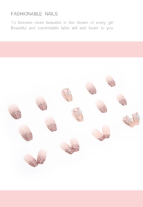 Detail of pink gradient press-on nails with 3D butterfly, pearls and glitter sequins