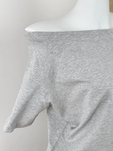 Close-up of the grey off-shoulder T-shirt showing detailed knit texture and stitching