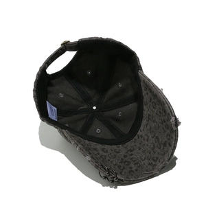 Close-up of distressed leopard print baseball cap interior with sweatband and metal rings