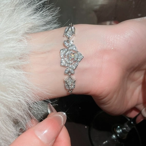 Close-up of elegant silver flower bracelet with sparkling zircons on a soft fur background