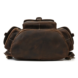 Detail view of crazy horse leather backpack base with vintage stitching and bronze hardware