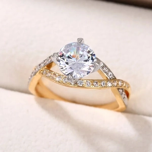 Macro shot of two-tone twisted band ring with classic four-prong setting and zircon stones