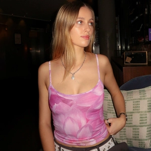 Detail of pink floral print crop top camisole with slim fit design on a model