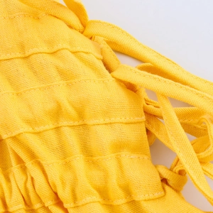 Yellow linen vacation maxi dress with tie shoulder straps and smocked pleated details