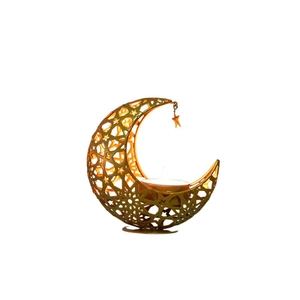 Golden crescent moon iron candle holder with star cutouts and warm candlelight glow