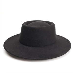 Detailed view of the flat top and wide brim texture of this black wool felt jazz boater hat