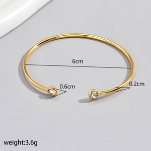 Detailed view of golden open cuff bracelet with 6cm inner diameter and size labels