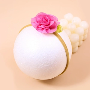 Pink chiffon rose flower nylon headband for babies on a soft pink background display