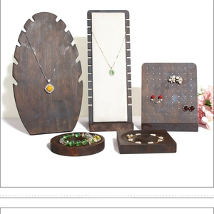 Macro view of solid wood jewelry display stands including necklace and earring holders