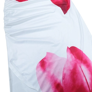 Detailed view of pink floral print and ruched waist design on white fabric