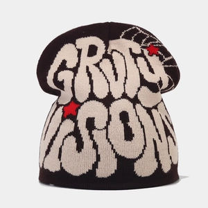 Detail of Grimy Season jacquard knit beanie with red stars and thick texture