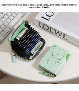Detail of mint green accordion card wallet with cartoon bear pattern and multi-card slots