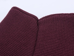 Macro shot of dark purple knitted fabric texture showing fine ribbed knit patterns