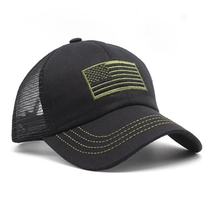 Detail of black trucker hat with olive green US flag embroidery and mesh back