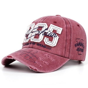 Detail of 1985 embroidery and distressed brim on vintage washed cotton baseball cap