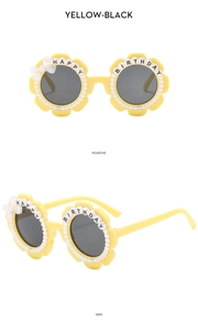 Detail view of yellow flower sunglasses with white pearls and Happy Birthday lettering