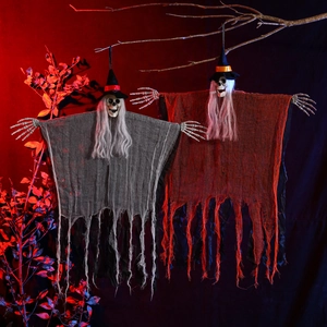 Close-up of hanging Halloween skeleton ghosts in gray and orange robes with wizard hats