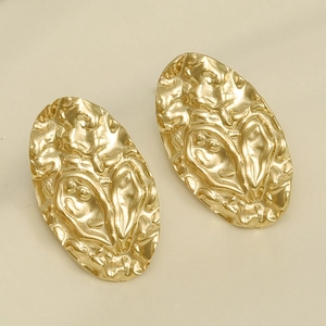 Macro detail of gold-plated 304 stainless steel earrings with hammered texture