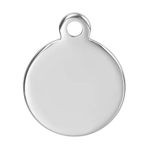 Macro detail of round silver stainless steel pendant charm with smooth polished surface