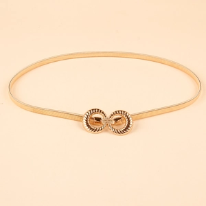 Detailed view of golden elastic metal belt with unique textured interlocking rings