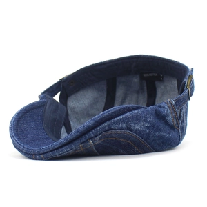 Classic washed denim blue cotton beret hat with adjustable metal buckle on white background