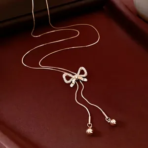 Rose gold bow pendant necklace with zircon crystals and Y-shaped snake chains