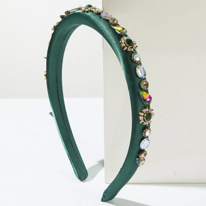 Padded dark green satin headband with rhinestone floral ornaments and pearly accents