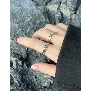 S925 sterling silver rings with texture and colored stones on grey rock surface