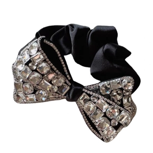 Luxurious black velvet bow hair tie with sparkling crystals for elegant women's hairstyles