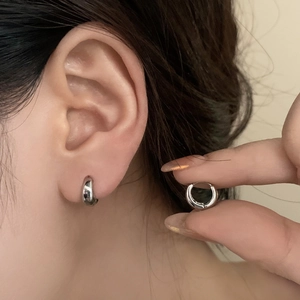 Minimalist silver hoop earrings for women shown worn on ear for an elegant style