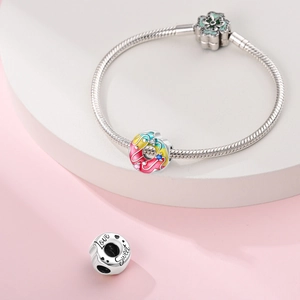 Silver snake chain bracelet featuring colorful enamel donut charm and Sweet engraving