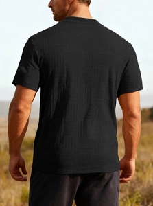 Close-up of men's black crew neck T-shirt featuring a textured waffle check pattern on back