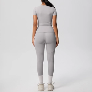 Rear view of grey short sleeve fitness yoga set showing slim fit and elastic fabric texture