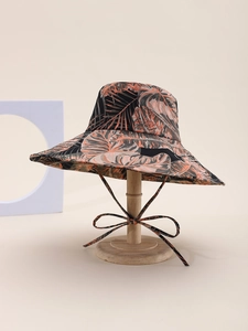 Close-up of tropical leaf print sun hat with matching chin strap and wide brim detail