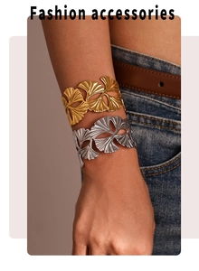 Detail of 18k gold plated ginkgo leaf open cuff bracelets on model for women
