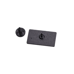 Detail shot of a black metal badge pin base with a round rubber clutch on white background