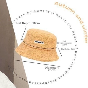 Detail view of beige faux fur bucket hat showing depth and circumference measurements