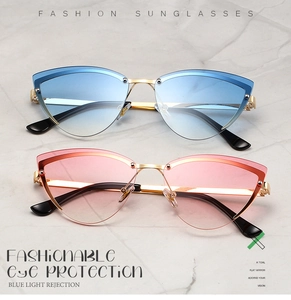 Close-up of cat-eye rimless sunglasses with blue and pink gradient lenses and gold metal frames