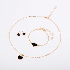 Detailed set of gold-plated necklace, bracelet, and earrings with black heart charms