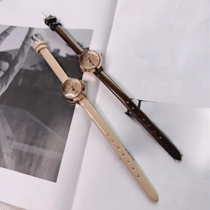 Detail of elegant ladies' quartz watches with slim leather straps in apricot and coffee