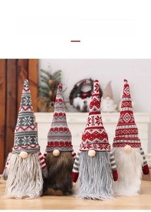 Detailed view of four knitted Christmas gnome wine bottle covers with snowflake patterns