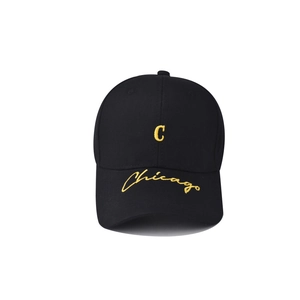 Detailed embroidery of yellow letter C and Chicago on a black cotton baseball cap