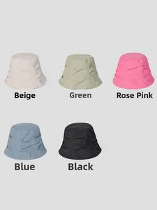 Flat lay of linen bucket hats in beige, green, pink, blue, and black with pleated texture