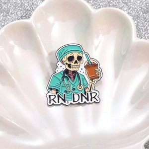 Skeleton nurse enamel brooch with RN DNR text, medical punk badge in shell tray